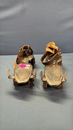 Pair of Simpson Sears Strap On Roller Skates