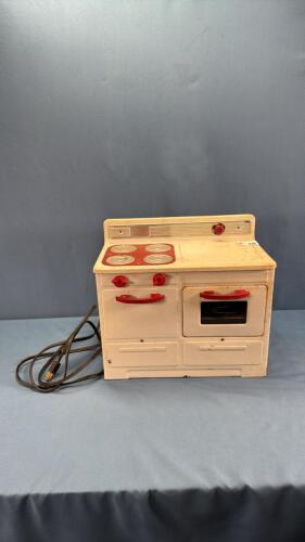 CHILD'S TIN STOVE WITH CORD