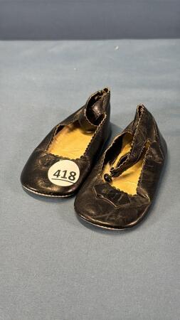 PAIR OF BLACK DOLL SLIPPERS