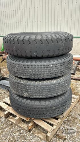 (4) 10-20 TIRES ON 8 BOLT RIMS