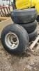 (4) TIRES ON 8 BOLT RIMS - DIFFERENT SIZED TIRES - 4