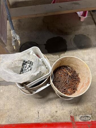 Two buckets of miscellaneous nails and screws