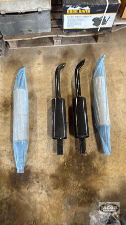 Four unused tractor mufflers