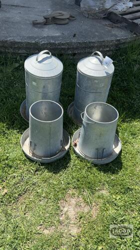 (4) CHICKEN FEEDERS. 2 WITH TOPS. ARE 22IN TALL. 2 OPEN TOPS ARE 14IN TALL