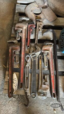 LOT OF PIPE AND ADJUSTABLE WRENCHES, AND CROWBAR