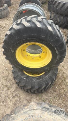 Pair of 12-16.5 tires on Jd 8 bolt wheels