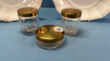 3 Dresser Jars with Gold Coloured Lids on 2 Plates - 2