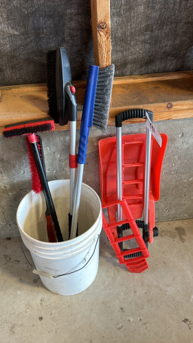 A lot of snow brushes and emergency snow shovel