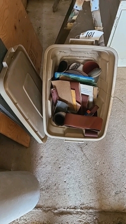 Tote of sanding, belts, and sanding discs