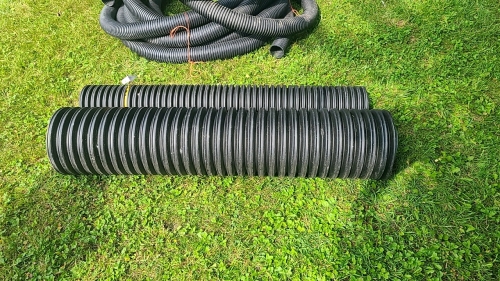 Two lengths of poly drainage tube